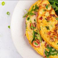 The California Omelette · Fresh eggs, peppers, tomatoes, ham, and creamy cheddar cheese. Served with a side of home fr...
