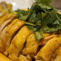 Hainanese Chicken Rice  · poached chicken leg, chicken broth rice balls, served w/ three dipping sauces: ginger scalli...