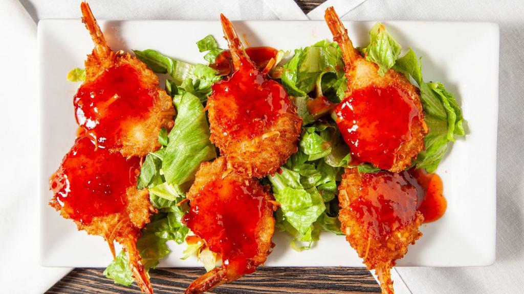 Crispy Coconut Shrimp · Butterflied coconut shrimp topped with a sweet and spicy chili sauce