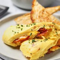 Bacon Lovers Omelette · Four fluffy eggs, chopped bacon, and shredded cheddar cheese.