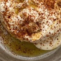 Hummus · Garnished with tahini aleppo and cumin.