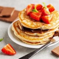 Nutella Pancakes · 3 freshly made pancakes, topped with syrup and a layer of Nutella. This is chocolatey goodne...