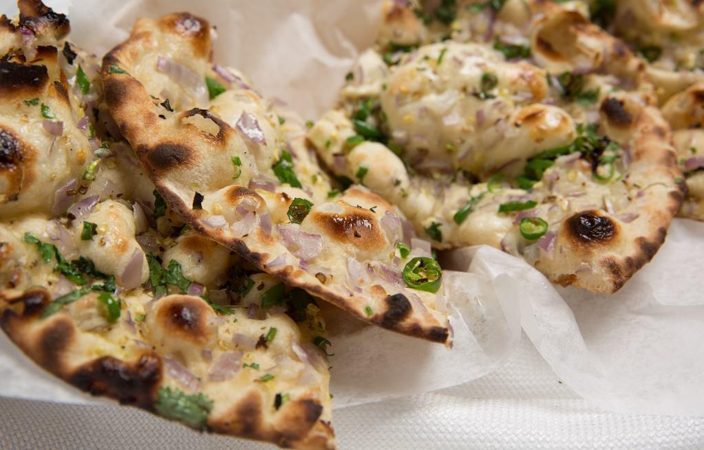 Naan · Tandoori fired white flour bread. Choice of garlic, onion chili, cheese, keema or cheese nut naan.