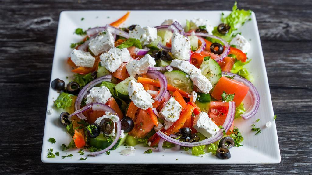 Greek Salad · Lettuce, tomatoes, cucumber, onions, black olives & greek feta cheese. Served with balsamic dressing
