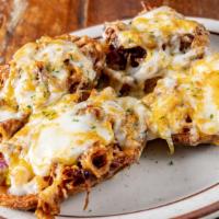 Loaded Potato Skins · Crispy potato skin stuffed with pulled pork, red onion, pickle, and melted cheddar cheese.