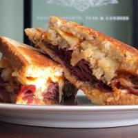 Reuben Panini · Pastrami grilled with sauerkraut, topped with Swiss cheese and Russian dressing.