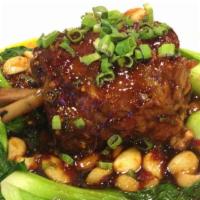 Pork Shank大蒜肘子 · Very little spicy. Served with baby bok choy, whole garlic and scallions with brown sauce.