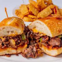 Philly Cheesesteak Sandwich · Shaved slow roasted prime roast beef, smothered with sautéed onions & peppers, topped with m...