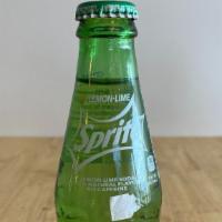 Classic Sprite · Glass bottle.

Need a bottle opener to open classic Sprite bottle.