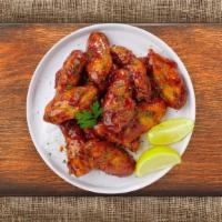 Sweet Sizzle Wings · Fresh chicken wings breaded, fried until golden brown, and tossed in honey and barbecue sauc...