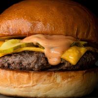 Award Winng Cheeseburger · Fresh ground beef seared with caramelized onions, topped with American cheese, pickles, and ...
