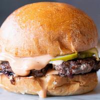 Burger · Fresh ground beef seared with caramelized onions, topped with pickles and secret sauce on to...
