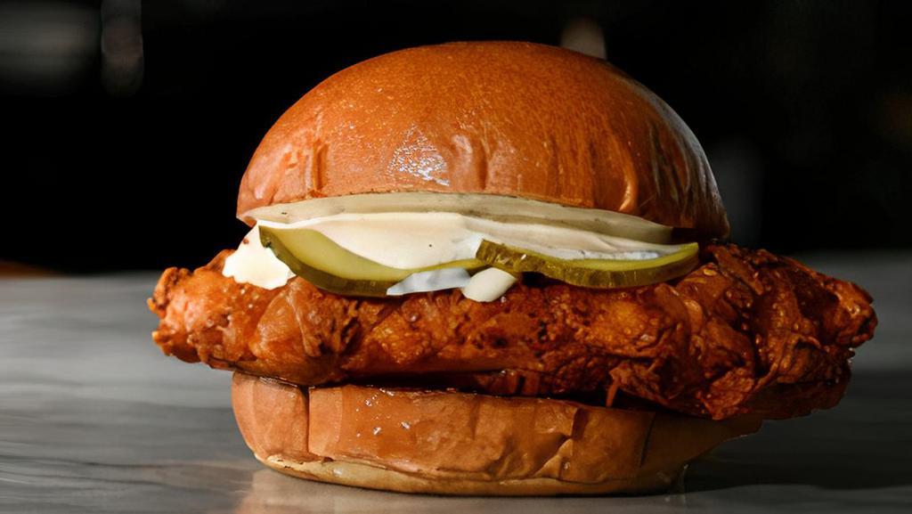 Nashville Hot Chicken Sandwich · Our famous buttermilk fried chicken dipped in sweet and spicy Nashville-Style Hot Sauce, dressed with ranch and pickles on a Brioche Bun