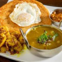 Bara Khana Set · Two bara served with black bean curry, cumin sautéed potatoes, aachar, mango chutney, kathma...