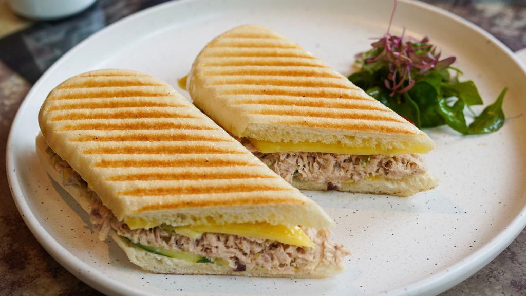 Tuna Melt Panini · Fresh tuna, mix salad, cheddar cheese, lettuce and tomatoes on european flatbread.