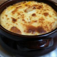 Moussaka · Oven-baked casserole of layered zucchini, eggplant, potatoes, spiced ground beef, and becham...