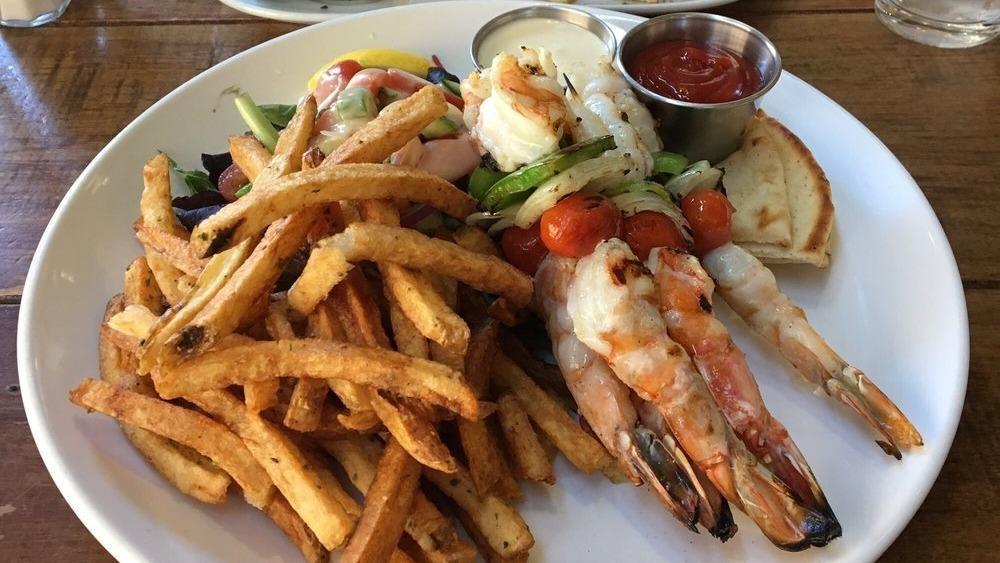 Shrimp Souvlaki · Skewers of grilled marinated shrimp served over rice pilaf or french fries with grilled pita.