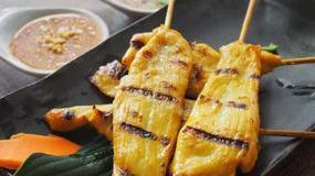 Chicken Satay (4 Pcs) · Grilled chicken skewers marinated with Thai spices and yellow curry powder. Served with pean...