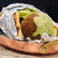 Falafel Wrap · Falafel with tahini sauce, lettuce, onion, and tomato inside pita bread. Comes wıth French f...