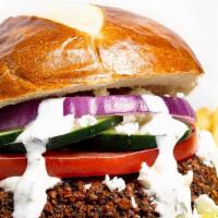 Vegan Burger · Vegan. Falafel with fresh onion, greens, tomato, pickle, hummus and special tahini sauce.