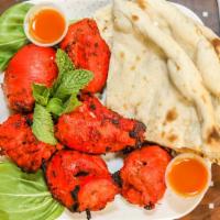 Chicken Tikka · Boneless cubes of chicken marinated with yogurt, herbs and spices, then grilled to perfection.