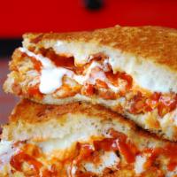 Buffalo Grilled Cheese · Crispy Chicken strips tossed in Franks red hot buffalo sauce with blue cheese on a Mozzarell...
