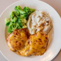 Bbq Chicken Dinner · Two grilled chicken breasts smothered in BBQ sauce and melted cheddar cheese. Served with tw...