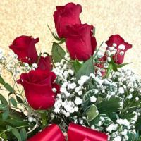 One Dozen Roses In A Vase · One dozen long stem roses in a vase with premium bow.