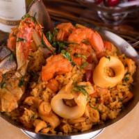 Arroz Con Mariscos · Traditional Peruvian paella with aji Amarillo seafood rice; accompanied with calamari, musse...