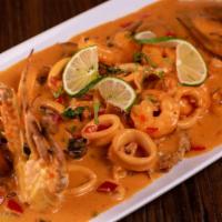 Pescado A Lo Macho · Two fried fish with creamy calamari, mussels, shrimps and crab seafood sauce on top. Accompa...