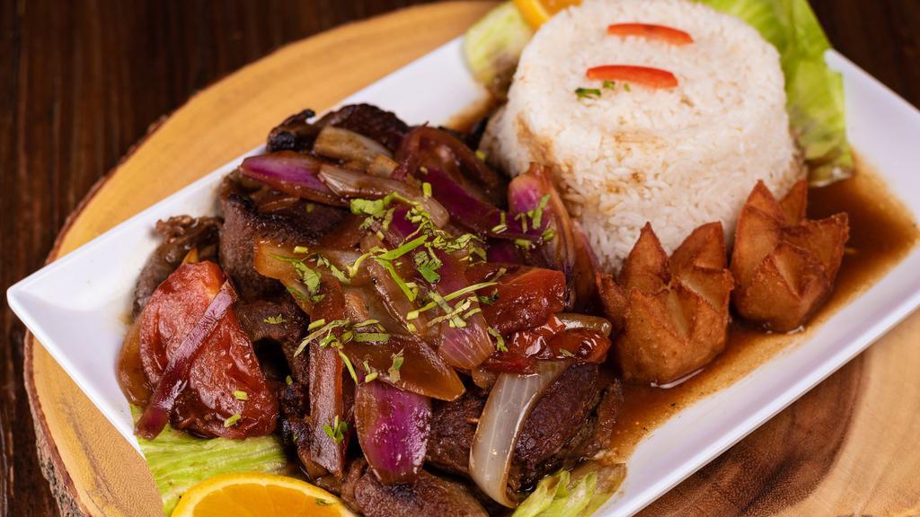 Bistek Encebollado · Tender steak marinated in a flavor-packed combination of onions and garlic sauce. Accompanied with white rice and French fries.