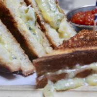 British Grilled Cheese · Cheddar, stilton (blue cheese) pickled Jalapeño, on white bread.