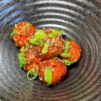Takoyaki • · Octopus Croquettes (6pcs), Sweet & Spicy Ginger Sauce, Sesame Seeds, & Scallions