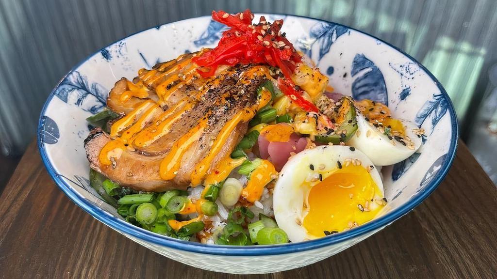 Chashu Pork Rice Bowl · soft egg, roasted corn, pickled daikon, pickled cucumbers, pickled red onions, pickled ginger, scallions, spicy mayo, sesame seeds