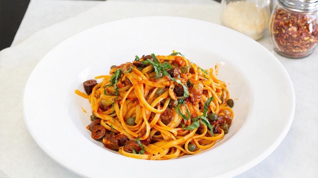 Linguine Puttanesca · Fresh tomatoes, sauteed garlic, capers, gaeta olives and anchovies in a spicy sauce.