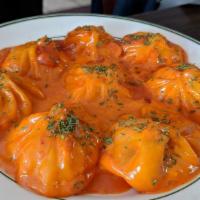 Momo In A Cream Sauce (8 Pieces) · Homemade dumpling filled with mixed vegetables and choice of meat sautéed over Homemade Chef...