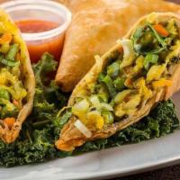 Vegetable Samosa (2) · Crisp turn over filled with spiced potatoes & peas.
