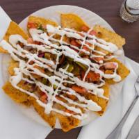 Nachos · Served with your choice of beans, cheese, sour cream, pico de gallo and picked jalapenos.