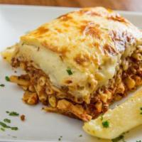 Pastitsio Greek Lasagna · Layer of ground beef, Greek pasta, kefalotyri cheese, and béchamel sauce. Served with a side...