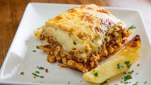 Pastitsio Greek Lasagna · Layer of ground beef, Greek pasta, kefalotyri cheese, and béchamel sauce. Served with a side salad or a cup of soup.