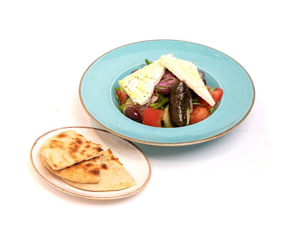 Greek Salad · Romaine lettuce, red onion, tomato, green peppers, stuffed grape leaves, kalamata olives, and imported Greek feta. Comes with pita bread.