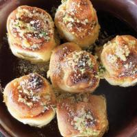 Garlic Knots · Garlic Knots made with fresh baked dough, garlic, olive oil, parsley, Romano Cheese.