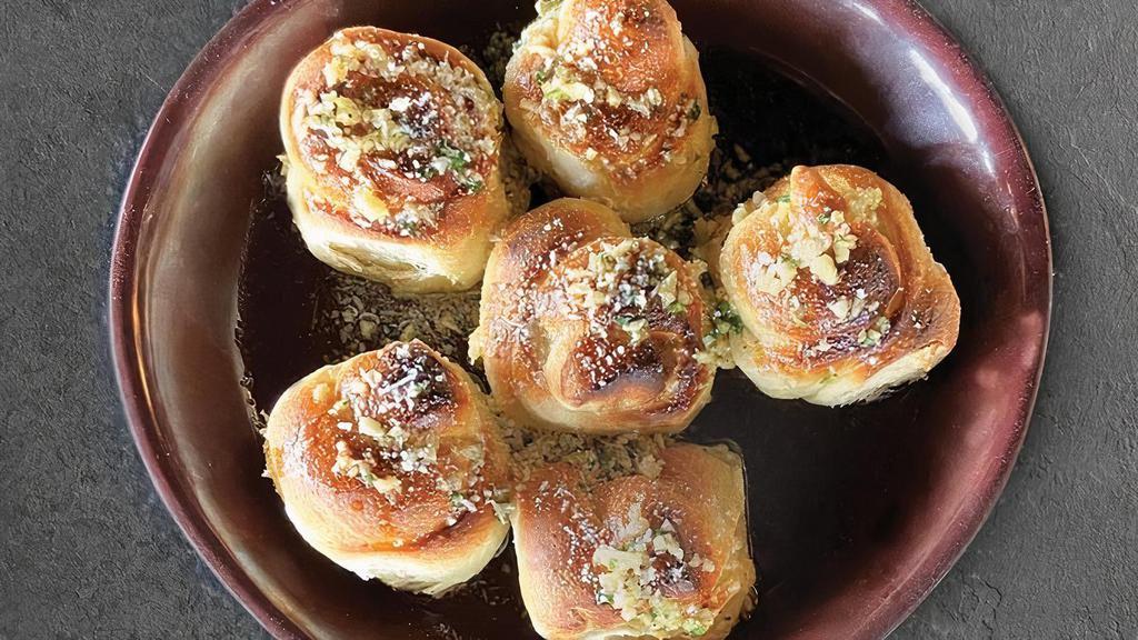 Garlic Knots · Garlic Knots made with fresh baked dough, garlic, olive oil, parsley, Romano Cheese.