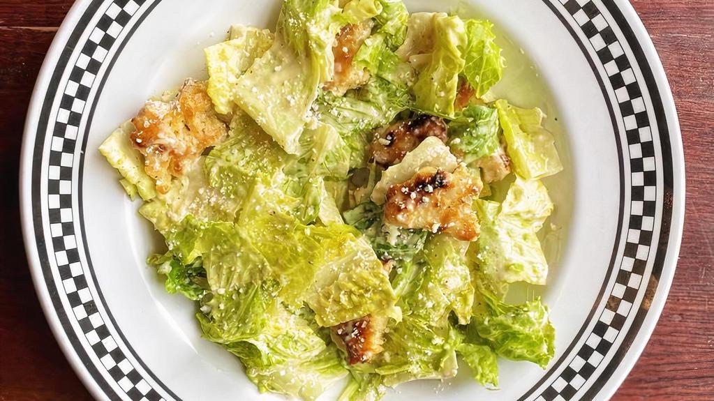 Caesar Salad · Romaine tossed in our homemade Caesar dressing with made-from-scratch focaccia croutons, sprinkled with Romano cheese