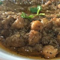 Channa Masala · Chickpeas cooked with ginger turmeric, tomato and garlic sauce.
