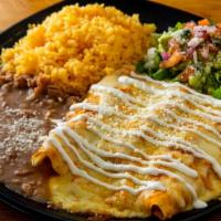 Enchiladas Rojas · Corn tortilla, choice of meat topped with cheese and cream. Served with rice and beans.