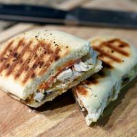 New Yorker Panini · Fresh Panini made with Turkey, pepperoni, sweet peppers, hot peppers, and balsamigrete. Serv...