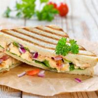 Turkey Club Panini · Fresh Panini made with Turkey, bacon, lettuce, tomato, and American cheese. Served on presse...