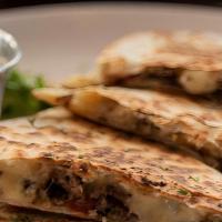 Steak Quesadilla · Mouthwatering Quesadilla made with fresh Mozzarella cheese, and cheddar cheese. Topped with ...