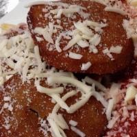 Eggplant Parmesan Dinner · Breaded Eggplant over a bed of Pasta covered in Homemade Sauce with melted Mozzarella and Pa...
